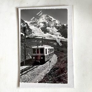 Vintage postcard of snow mountains. The alps? Unique. With an old cable car.